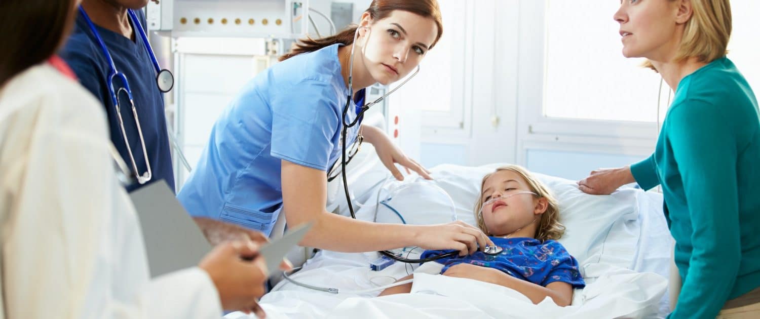 Mother And Daughter With Staff In Intensive Care Unit